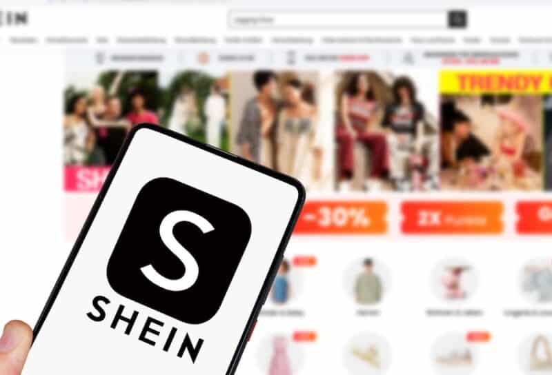 Shein logo online marketplace ecommerce on a mobile phone and computer in Stuttgart, Germany.