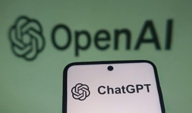 OpenAI ChatGPT logo on a smartphone screen with a blurred background.