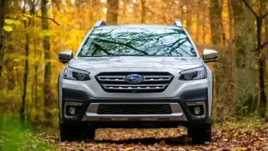Subaru Outback in the autumn forest.