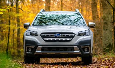Subaru Outback in the autumn forest.