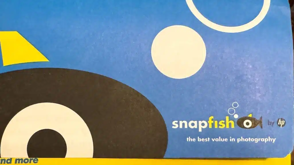 Hand holds a package of SnapFish brand printed photos