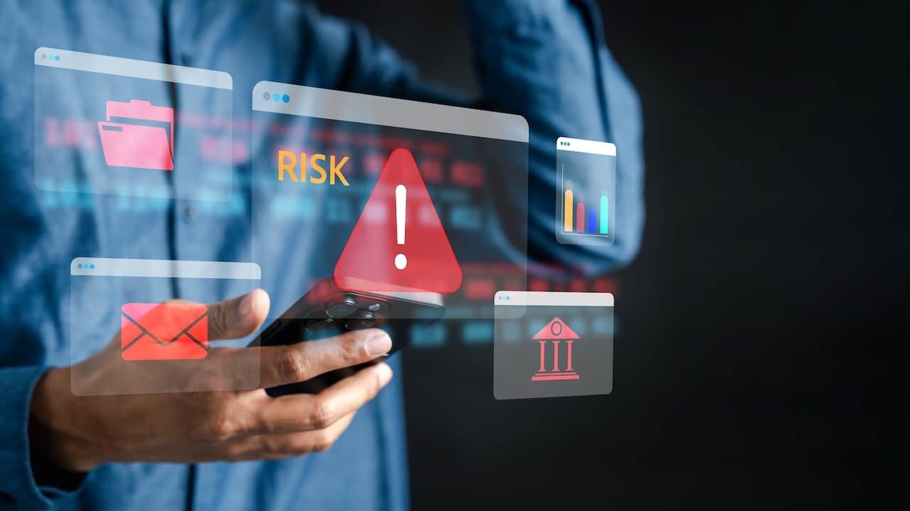 Financial risk and cybersecurity with red warning, risk alert message, and digital banking fraud, data breach, and online threats.
