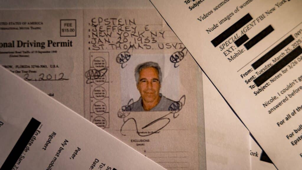 A document from the U.S. Department of Justice release of the Jeffrey Epstein files, showing Jeffrey Epstein, is seen photographed on a desk.