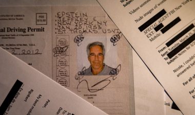 A document from the U.S. Department of Justice release of the Jeffrey Epstein files, showing Jeffrey Epstein, is seen photographed on a desk.