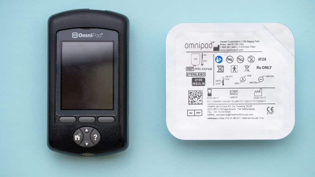 Insulet Omnipod wireless insulin pump controller with a pod for diabetes treatment.