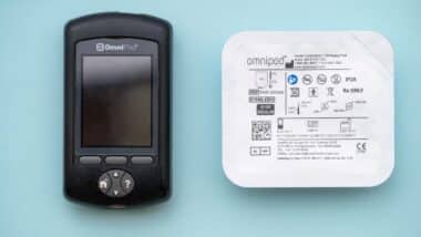 Insulet Omnipod wireless insulin pump controller with a pod for diabetes treatment.