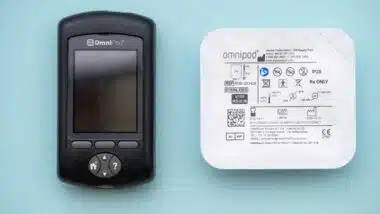Insulet Omnipod wireless insulin pump controller with a pod for diabetes treatment.