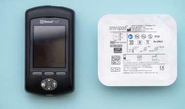 Insulet Omnipod wireless insulin pump controller with a pod for diabetes treatment.