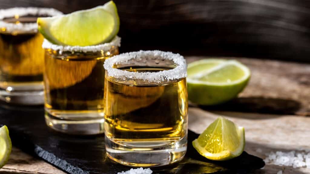 shots of gold Mexican tequila with lime and salt.