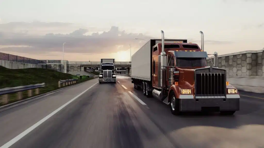 American style truck on freeway pulling load