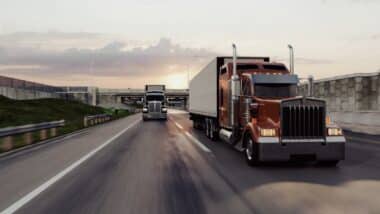 American style truck on freeway pulling load