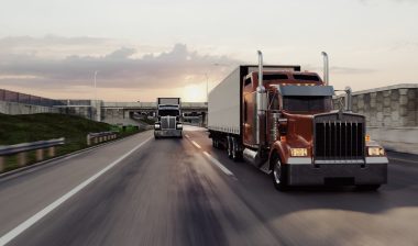 American style truck on freeway pulling load