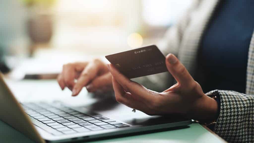 hands and laptop with credit card for online shopping,