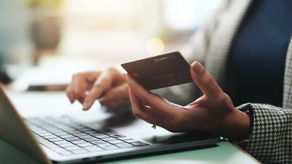 hands and laptop with credit card for online shopping,