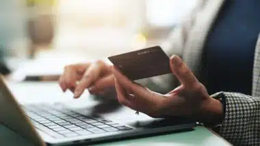 hands and laptop with credit card for online shopping,