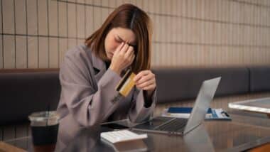 Asian woman stressed over credit card debt