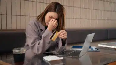 Asian woman stressed over credit card debt