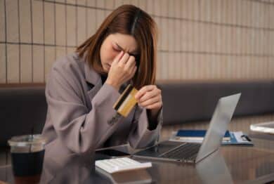 Asian woman stressed over credit card debt