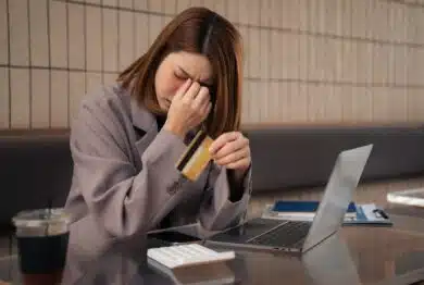 Asian woman stressed over credit card debt