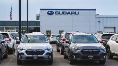 Close-up view of Subaru dealership building and new Subaru cars in foreground, Subaru of Yorkville is part of Subaru of Utica dealership