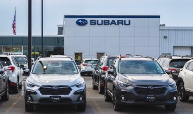 Close-up view of Subaru dealership building and new Subaru cars in foreground, Subaru of Yorkville is part of Subaru of Utica dealership