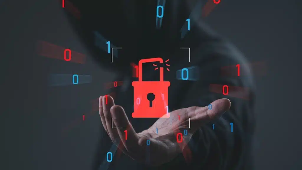 Cybersecurity breach concept with broken padlock and binary code over hooded hacker background, symbolizing data breach