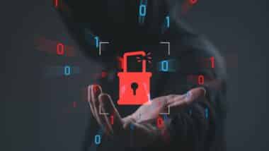 Cybersecurity breach concept with broken padlock and binary code over hooded hacker background, symbolizing data breach