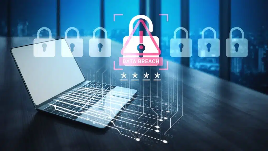 A laptop sits in a modern office, showcasing a digital alert for data breach with lock visuals, emphasizing cybersecurity and the importance of protecting sensitive information