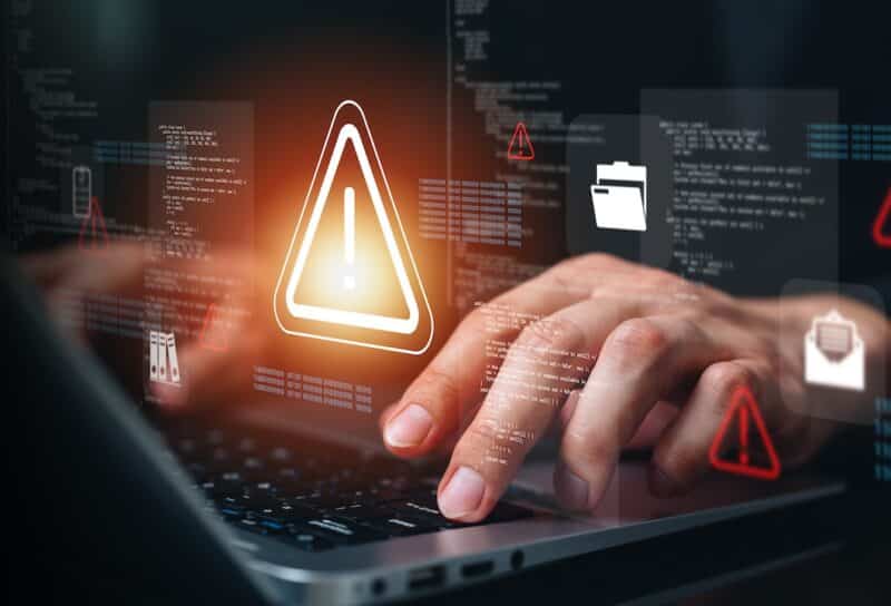 Cybersecurity threat alert on laptop with digital warning interface, malware detection