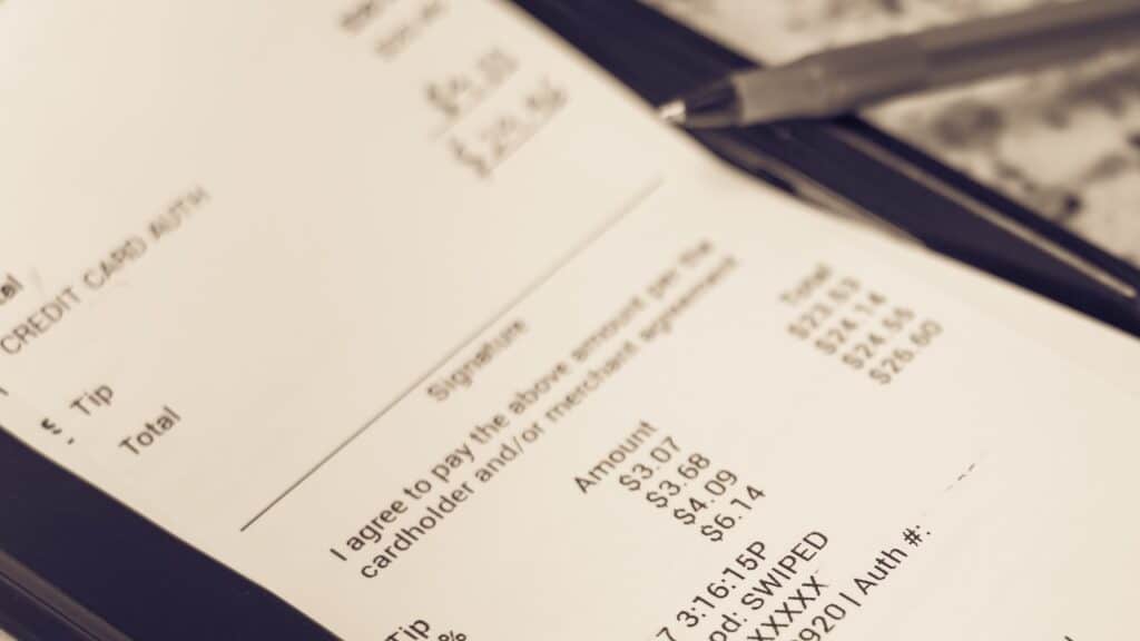 a receipt with hand written total amount and tipping