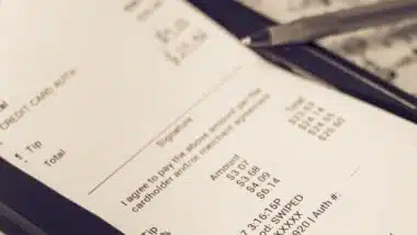 a receipt with hand written total amount and tipping