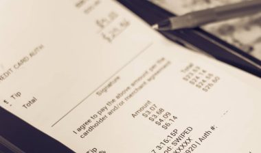 a receipt with hand written total amount and tipping