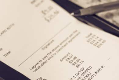 a receipt with hand written total amount and tipping