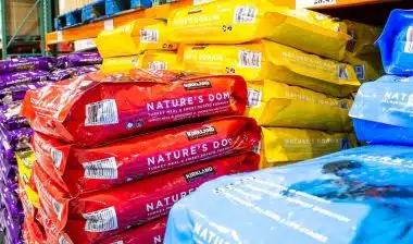 A view of several varieties of Kirkland Signature Nature's Domain dog food on display at a local Costco.