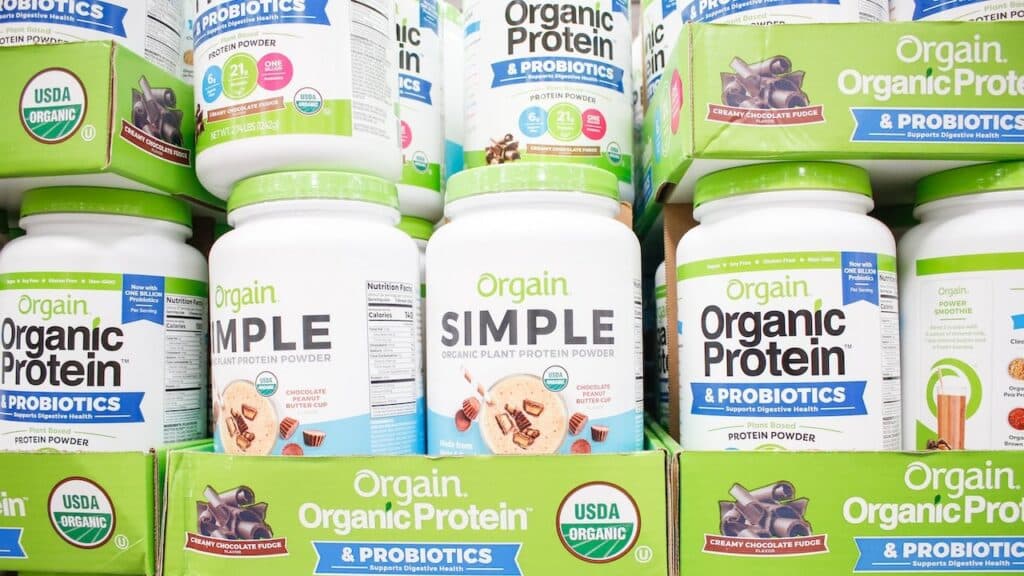 A view of several containers of Orgain protein powder products
