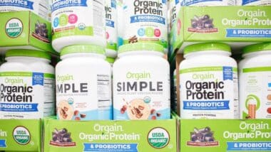 A view of several containers of Orgain protein powder products
