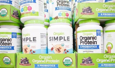 A view of several containers of Orgain protein powder products