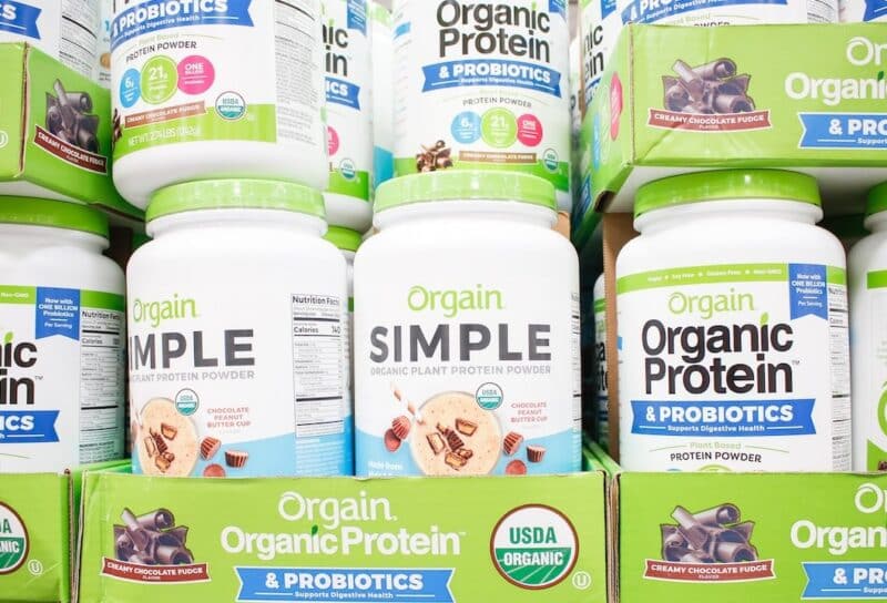 A view of several containers of Orgain protein powder products