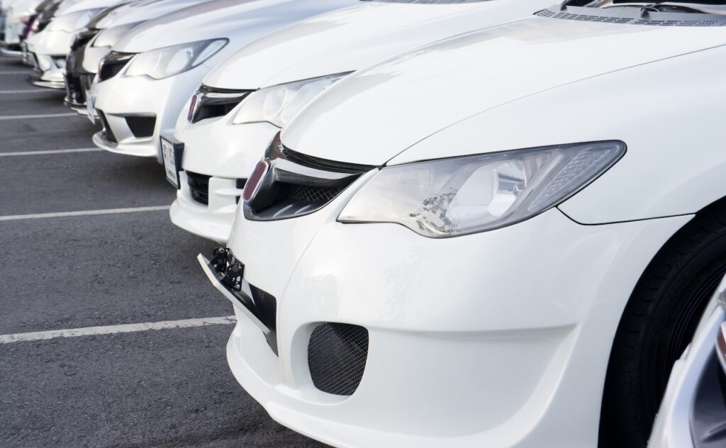 Row of white Honda cars at dealer