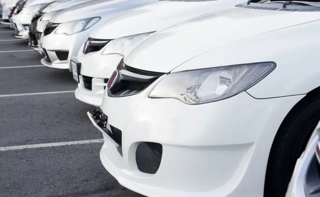 Row of white Honda cars at dealer
