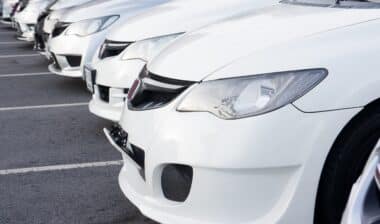 Row of white Honda cars at dealer