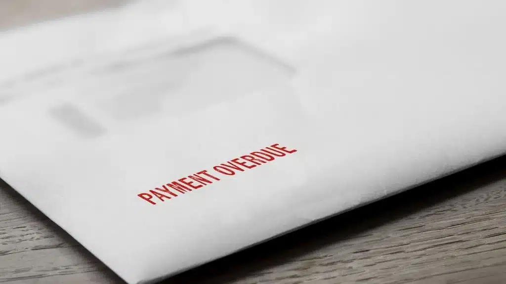 Payment overdue letter stamped in red on an evelope.