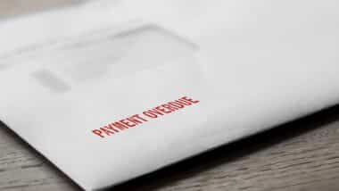 Payment overdue letter stamped in red on an evelope.