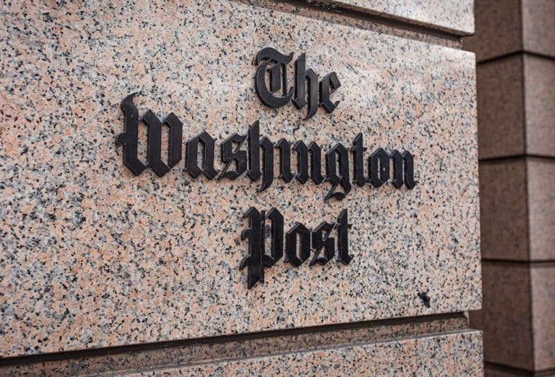loseup of The Washington Post newspaper logo sign on the facade of a building downtown Washington DC