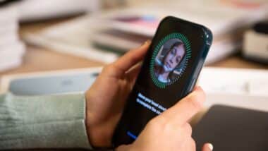 A person holding an iPhone during the Face ID setup process