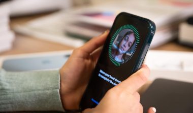 A person holding an iPhone during the Face ID setup process