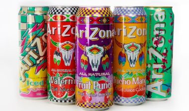 Vibrant arrangement of Arizona beverage cans featuring iced tea, watermelon, fruit punch, and much more on plain background.