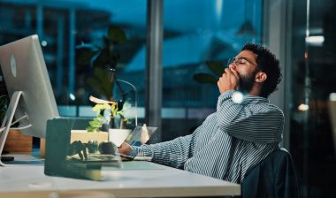 Tired, businessman and night with yawn on computer for project deadline or exhausted in office.
