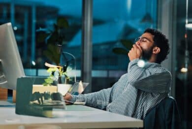 Tired, businessman and night with yawn on computer for project deadline or exhausted in office.