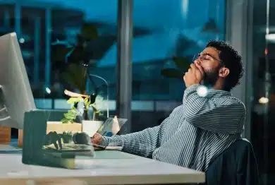 Tired, businessman and night with yawn on computer for project deadline or exhausted in office.